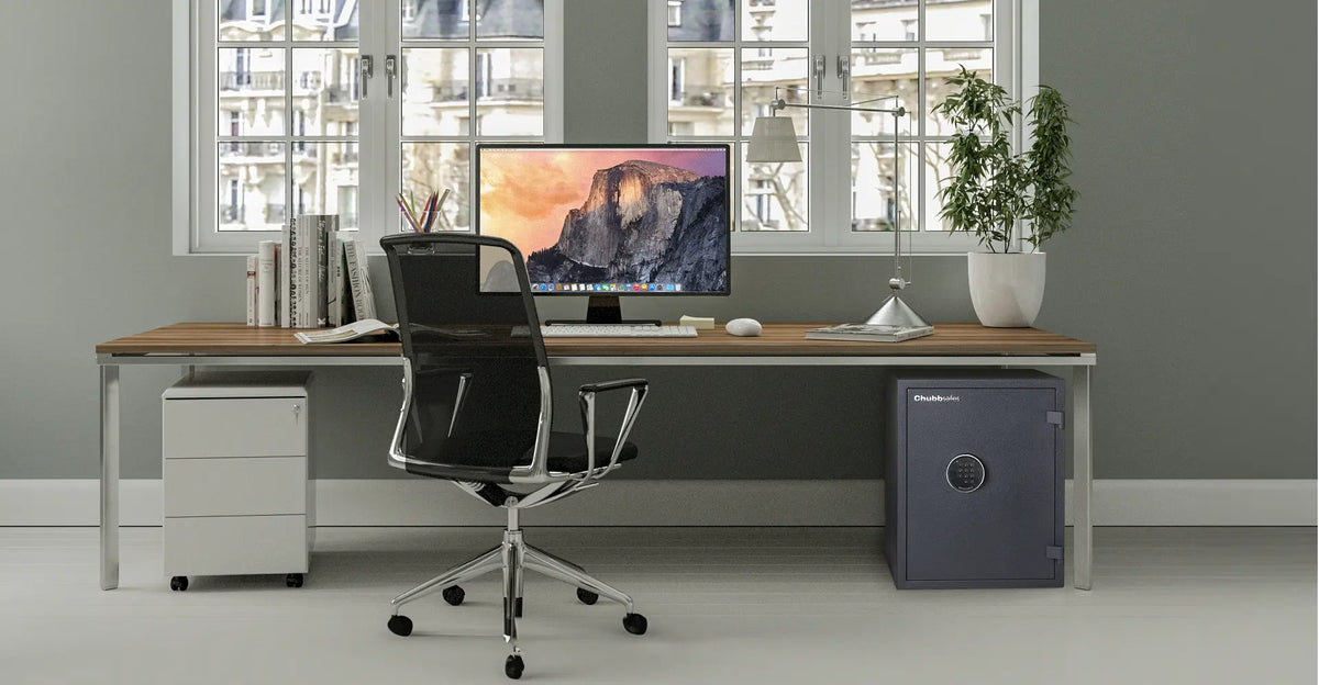 Modern office with a Chubbsafes digital safe beside a desk, illustrating secure storage for business valuables and documents.